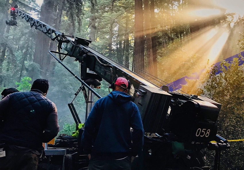 A professional film crew operates a camera jib.