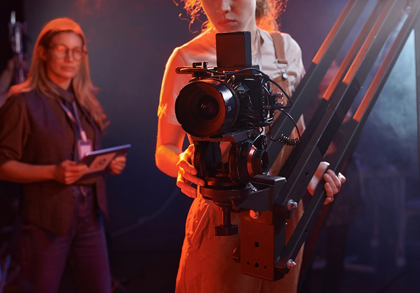 a yound camera operator holds a camera jib.
