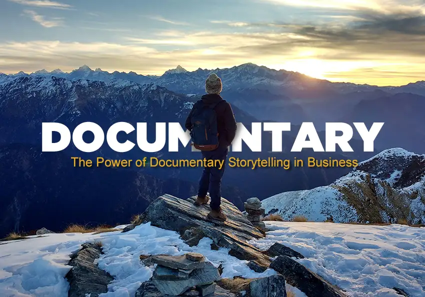 A man stands on top of a mountain.