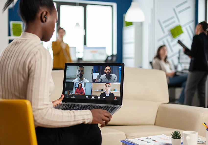 A video meeting in Zoom happens inside an office.