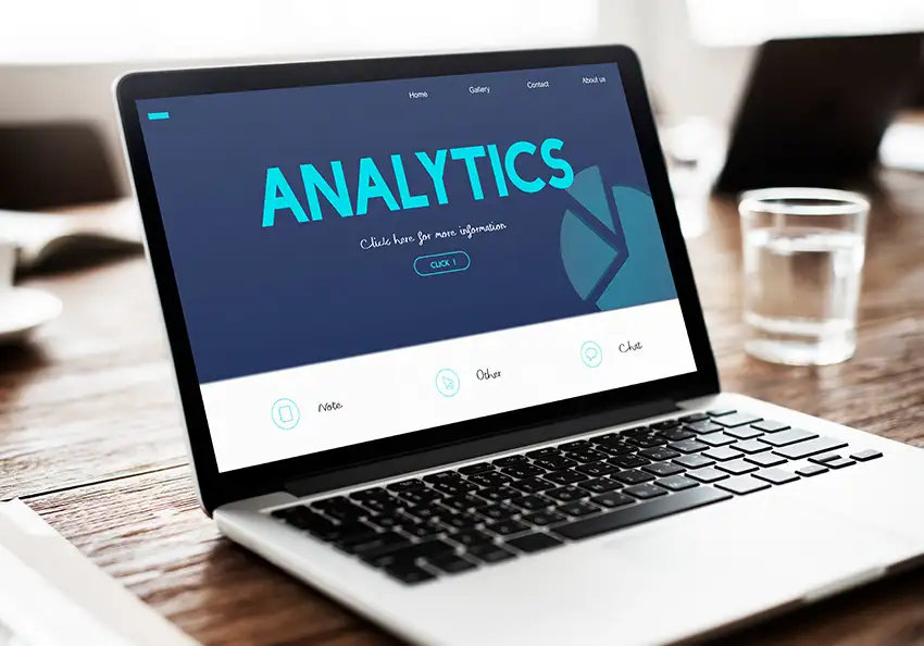 A laptop displays the word analytics.