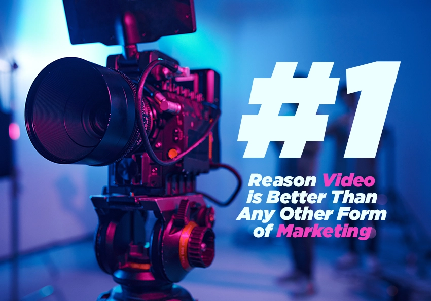 A professional video camera in a studio filled with blue and magenta light.