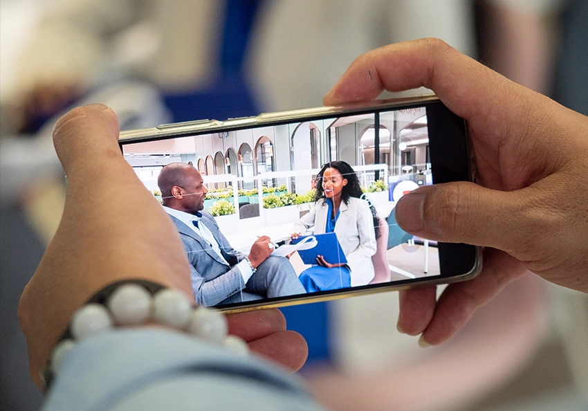 A cinematographer prepares the camera for filming.